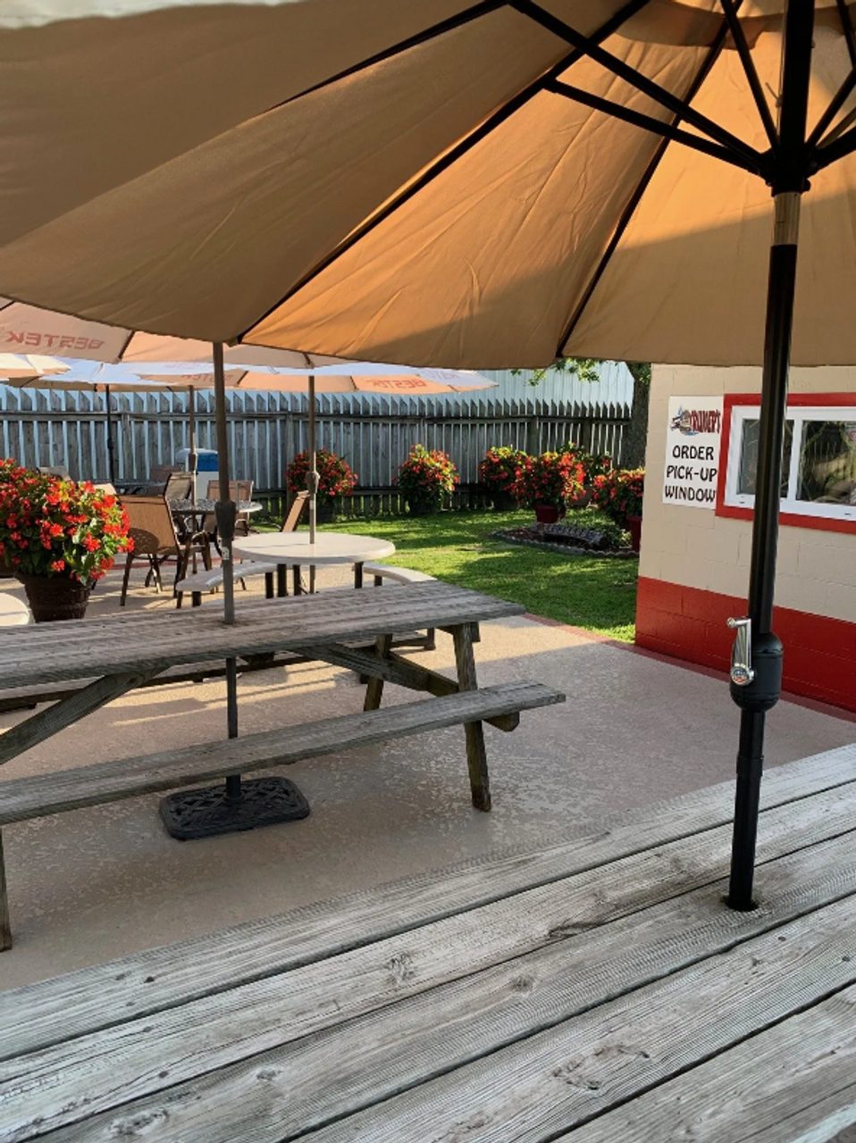 Picnic table seating under umbrellas at Cruiser's